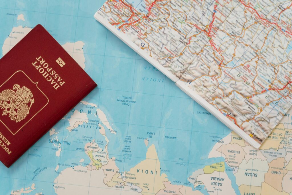 Flat lay of a passport and map, symbolizing travel adventure and exploration.